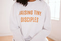 Adult Raising Tiny Disciples White Sweatshirt